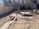 View of backyard featuring a hammock swing, brick edging, and a small fountain at 1473 S Monaco S Pkwy, Denver, CO 80224