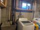 Basement laundry area with a utility sink and newer washer and dryer units at 1473 S Monaco S Pkwy, Denver, CO 80224