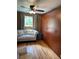 Charming bedroom with a comfortable sofa, hardwood floors, and built-in wardrobe at 1473 S Monaco S Pkwy, Denver, CO 80224