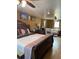 Spacious bedroom with hardwood floors, complemented by a comfortable seating area and ceiling fan at 1473 S Monaco S Pkwy, Denver, CO 80224