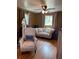Cozy bedroom with lots of natural light, featuring a comfortable sofa and hardwood floors at 1473 S Monaco S Pkwy, Denver, CO 80224