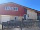 Two-story home featuring a combination of brick and red siding and a wheelchair ramp at 1473 S Monaco S Pkwy, Denver, CO 80224