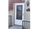 Charming front entrance with a decorative white door, address plaque, and brick facade at 1473 S Monaco S Pkwy, Denver, CO 80224