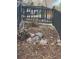 Landscaped front yard featuring decorative rocks, mulch, and a charming black fence at 1473 S Monaco S Pkwy, Denver, CO 80224