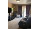 Cozy living room featuring carpeting, a plush leather couch, and an entertainment center at 1473 S Monaco S Pkwy, Denver, CO 80224