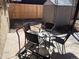 Covered patio with a table and four chairs set on a concrete slab surrounded by a wooden fence at 1473 S Monaco S Pkwy, Denver, CO 80224