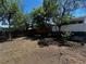 Backyard landscape showcasing lush trees, fencing, and open space at 8319 Quivas Way, Denver, CO 80221