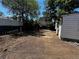 Backyard featuring a detached structure, ladder, and wood borders, framed by greenery at 8319 Quivas Way, Denver, CO 80221