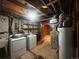 Basement utility area with washer, dryer, water heater, and furnace, plus storage shelving at 8319 Quivas Way, Denver, CO 80221
