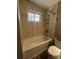 Nicely renovated bathroom featuring shower, toilet, and towel rack at 8319 Quivas Way, Denver, CO 80221