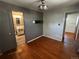 Cozy bedroom featuring hardwood floors, neutral walls, and natural lighting at 8319 Quivas Way, Denver, CO 80221