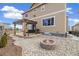 Backyard featuring a fire pit, lounge swing, and a gravel area at 10913 Ledges Rd, Parker, CO 80134
