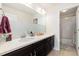 Bright bathroom featuring vanity with sink and drawers, mirror, and a shower behind a glass panel at 10913 Ledges Rd, Parker, CO 80134