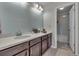 Bathroom vanity with cabinets and a view to the tub at 10913 Ledges Rd, Parker, CO 80134