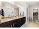 Bathroom features a dual-sink vanity with granite countertops, updated fixtures, and a separate shower at 10913 Ledges Rd, Parker, CO 80134