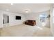 Second floor bonus room, carpeted, with a TV and a brown comfy sofa at 10913 Ledges Rd, Parker, CO 80134