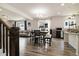 Inviting dining area with hardwood floors, modern lighting, and convenient access to the kitchen and living room at 10913 Ledges Rd, Parker, CO 80134