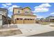 The home's attractive two-car garage and complementary landscape present a welcoming first impression at 10913 Ledges Rd, Parker, CO 80134