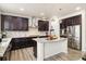 Modern kitchen with dark wood cabinets, granite countertops, and stainless steel appliances at 10913 Ledges Rd, Parker, CO 80134