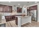Modern kitchen features stainless steel appliances, dark cabinets, granite countertops, and island with seating at 10913 Ledges Rd, Parker, CO 80134
