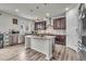 Kitchen island with stainless steel appliances, and dark wood cabinets at 10913 Ledges Rd, Parker, CO 80134