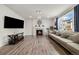 Bright living room with hardwood floors, stone fireplace, and large windows providing ample natural light at 10913 Ledges Rd, Parker, CO 80134