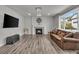 Cozy living room featuring a fireplace, modern lighting, and wood-style floors at 10913 Ledges Rd, Parker, CO 80134
