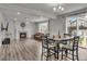 Bright living room with fireplace, wood floors, dining table, and open floor plan at 10913 Ledges Rd, Parker, CO 80134