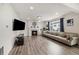 Bright living room with hardwood floors, stone fireplace, and large windows providing ample natural light at 10913 Ledges Rd, Parker, CO 80134