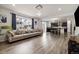 Spacious living room with hardwood floors, large windows, and a view of the kitchen at 10913 Ledges Rd, Parker, CO 80134