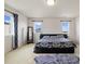 Bright main bedroom with plush carpet, large windows, and a dark wood platform bed frame at 10913 Ledges Rd, Parker, CO 80134