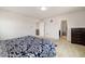 Spacious bedroom with plush carpet, a dark wood dresser, and ensuite bathroom at 10913 Ledges Rd, Parker, CO 80134