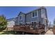 Two-story home features backyard with deck and wood railing at 8888 S Dudley St, Littleton, CO 80128