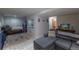 Open-concept finished basement featuring a spacious living area, bedroom, and bathroom at 8888 S Dudley St, Littleton, CO 80128