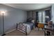 Inviting bedroom featuring a cozy bed, a functional desk area, and a calming color scheme at 8888 S Dudley St, Littleton, CO 80128