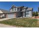 Charming home with well-manicured lawn, attached garage, and inviting curb appeal at 8888 S Dudley St, Littleton, CO 80128
