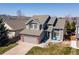 Charming home with a well-maintained front yard, gray siding and two-car garage at 8888 S Dudley St, Littleton, CO 80128