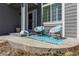 Cozy front porch with outdoor seating, a patterned rug, and neutral siding at 8888 S Dudley St, Littleton, CO 80128