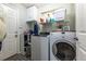 Functional laundry room equipped with modern washer and dryer at 8888 S Dudley St, Littleton, CO 80128