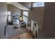 Open-concept living room with high ceilings, large windows, and stylish furniture at 8888 S Dudley St, Littleton, CO 80128