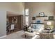 Bright living room boasts high ceilings, neutral tones, and an open layout to the dining area at 8888 S Dudley St, Littleton, CO 80128