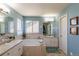 Light and airy main bathroom featuring a soaking tub, double vanity, and lots of natural light at 8888 S Dudley St, Littleton, CO 80128