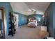 This expansive main bedroom features a seating area, ceiling fan, and ensuite bathroom at 8888 S Dudley St, Littleton, CO 80128