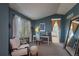 Inviting office area with blue walls, white desk, cushioned chair and decoratives at 8888 S Dudley St, Littleton, CO 80128