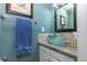 Stylish powder room with a unique glass vessel sink and granite countertop at 8888 S Dudley St, Littleton, CO 80128