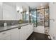 Stylish bathroom featuring a double vanity and vibrant tile in the shower at 14 S Grape St, Denver, CO 80246
