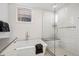Serene bathroom features a soaking tub and walk-in shower with white subway tile at 14 S Grape St, Denver, CO 80246