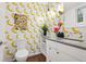 Unique bathroom features playful banana wallpaper and modern vanity with flamingo decor, plus stylish fixtures at 14 S Grape St, Denver, CO 80246