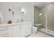Modern bathroom featuring a glass enclosed shower with bench, sleek vanity with ample storage, and tile flooring at 14 S Grape St, Denver, CO 80246
