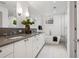 Bright bathroom with dual sinks, soaking tub, and glass-enclosed shower at 14 S Grape St, Denver, CO 80246